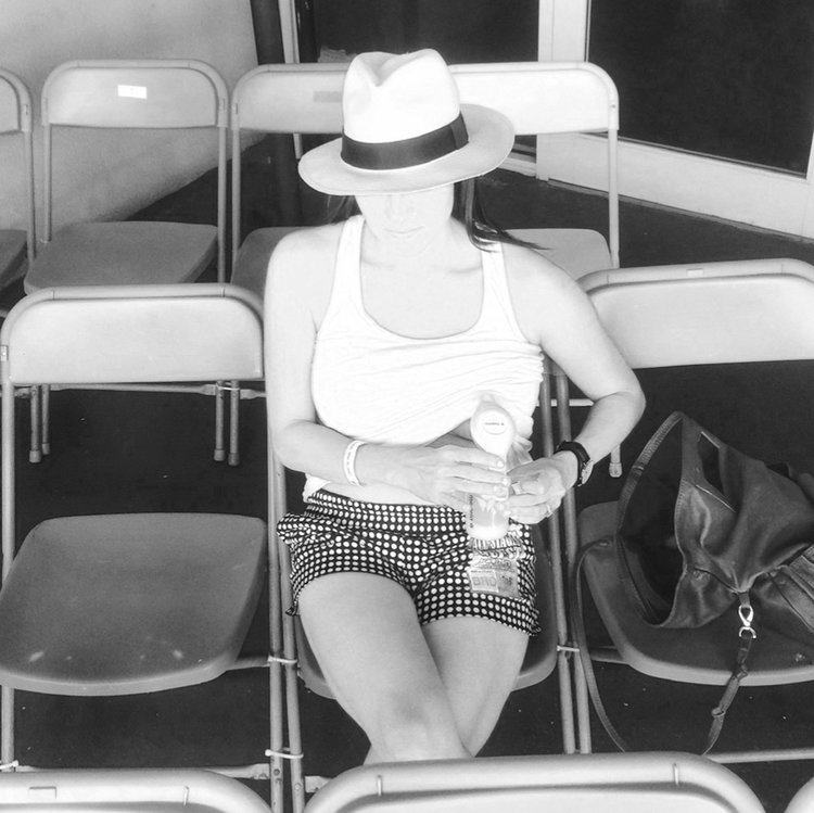 woman sitting pumping breastmilk