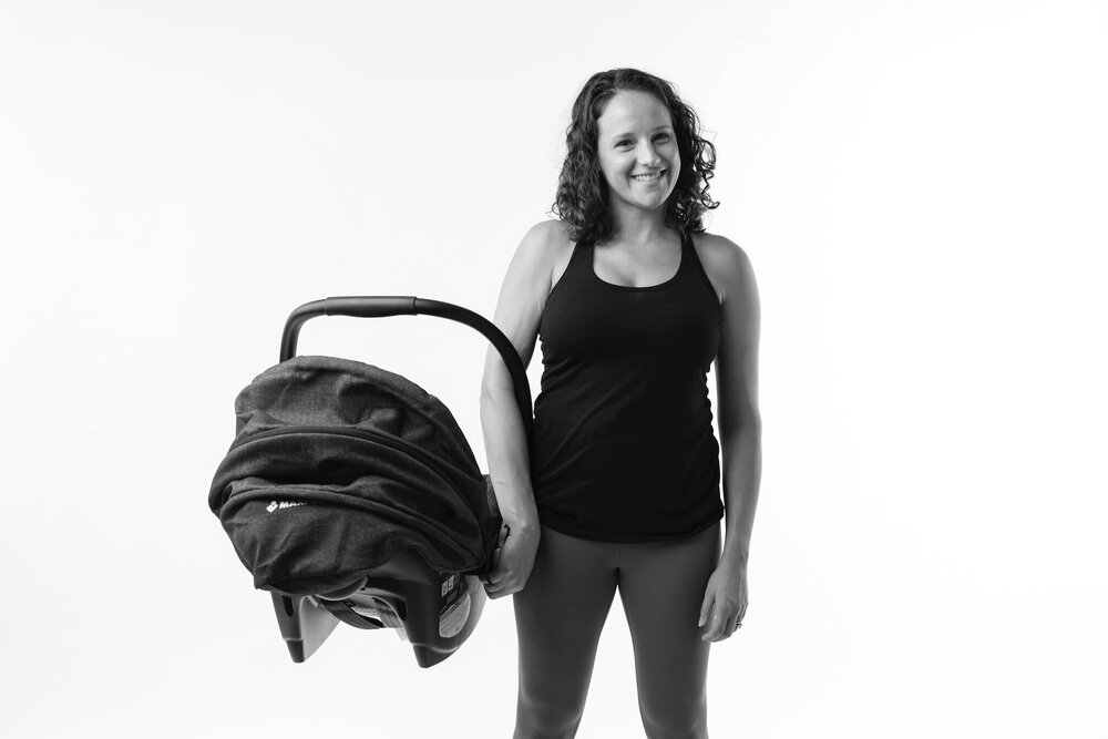 woman carrying carseat