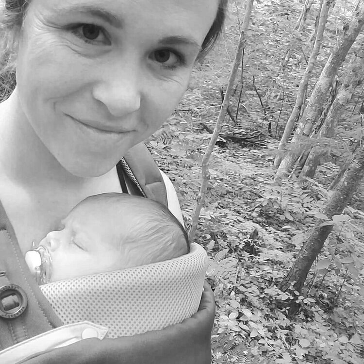 woman hiking with newborn