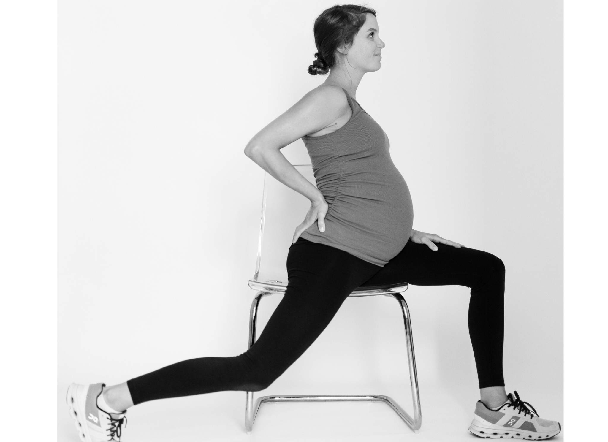 side view of a woman sitting sideways on a chair, her back leg behind her to stretch her hip flexor