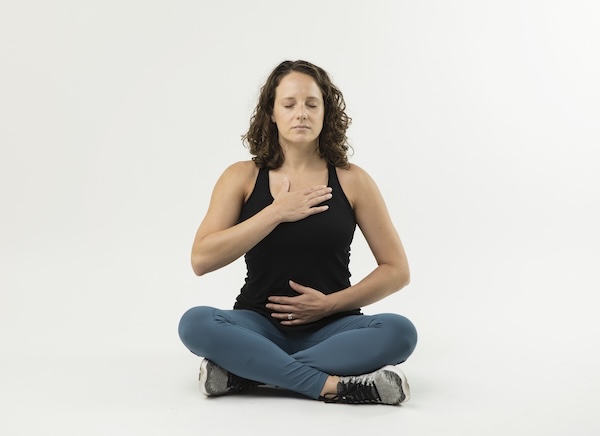 woman sitting breathing mindfully doing pelvic floor exercises after hysterectomy 