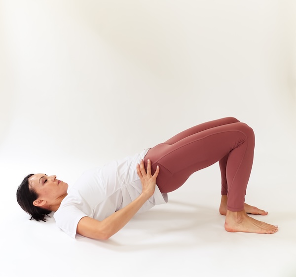 woman performing a bridge exercise to help with caffeine and pelvic floor dysfunction